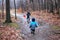 Brothers run through a forest trail in the rain