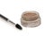 A brow pomade in blonde shade with brush isolated on a white background