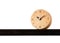 Brown alarm retro classic wooden design clock placing on shelf with ten minute pass ten