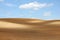 Brown arable hills against blue sky