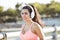 Brown and attractive Venezuelan woman, goes running with big headphones to listen music