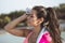 Brown and attractive Venezuelan woman, wipes the sweat from her forehead with a towel after exercising