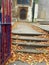 Brown autumn leaves lay fallen to steps of this London church