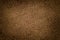 Brown background from a soft upholstery textile material, closeup