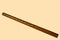 Brown bamboo flute instrument isolated on a soft yellow background