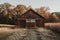 Brown barn on farm landscape