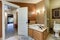 Brown bathroom interior showcases corner jetted tub