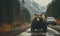 Brown bear in front of car crossing the road.Wild grizzly bear crossing into traffic on mountain road. Wildlife concept