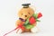 Brown bear wearing a graduation cap and red roses.