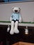 Brown bear and white lace bear doll, sitting quietly on the display stand, the light shining on the bear