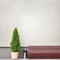 Brown bench, metal trash bin and thuja near the wall