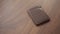 Brown bespoke leather wallet on walnut wood table