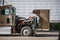 Brown big rig semi truck with open hood for checking that the engine is working properly during a stop in the delivery schedule