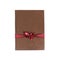 Brown book gift. With red ribbon and bow. Isolated