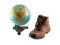 Brown boot next to a rotating globe