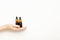 Brown bottles with pipette in female hand, top view. Serum, essential oil for skin care, aromatherapy. Cosmetic organic spa