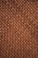 Brown braided leather background. Vertical background.