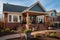 brown brick farmhouse with a narrow, gabled front entry