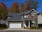 Brown Brick House with Fall Trees Background