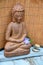 Brown Buddha statue with bamboo reed background