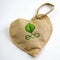 A brown burlap bag in the shape of a green heart