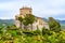 The Brown Castle beyound green trees in Portofino, Genoa metropolitan area, Liguria, Italy