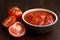 Brown ceramic bowl of chopped tinned tomatoes.