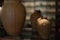 Brown ceramic jug with Balinese rangda carvingg