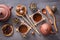 Brown ceramic teapot with cups on special wooden stands, various attributes of the tea ceremony, an assortment of green tea