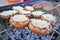 Brown champignon mushrooms being cooked on char grill. Stuffed mushrooms