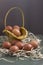 Brown chicken eggs in yellow basket and on the hay, green table, gray background. Easter preparations, Concept