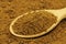 Brown chicory powder in a wooden spoon