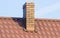 Brown chimney on roof of house on sunny day