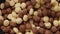 Brown choco cereal balls falling into a bowl, close up