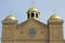 Brown Christian Church with Three Gold Domes