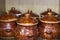 Brown clay pots with a pattern stand in a home cabinet