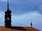 Brown clay tile roof and black metal covered clock tower