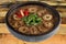 Brown color vermicelli with pork intestine on black bowl  on white background. Traditional Taiwan food