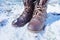 Brown combat boots in the winter snow