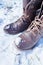 Brown combat boots in the winter snow