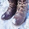 Brown combat boots in the winter snow