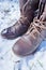 Brown combat boots in the winter snow