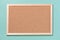 Brown corkboard for notes on a green background