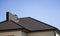 Brown corrugated metal profile roof installed on a modern house. The roof of corrugated sheet. Roofing of metal profile