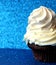 Brown Cupcake with cream on blue background