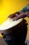 Brown Djembe With Hands On Yellow Bk