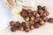 Brown dry soap nuts Soapberries, Sapindus Mukorossi for organic laundry and gentle natural skin care on light background.