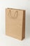 Brown ecological paper bag on white background. Store packaging