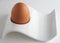 Brown egg in modernist eggcup