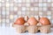 Brown eggs in a cardboard tray top view. Selected focus